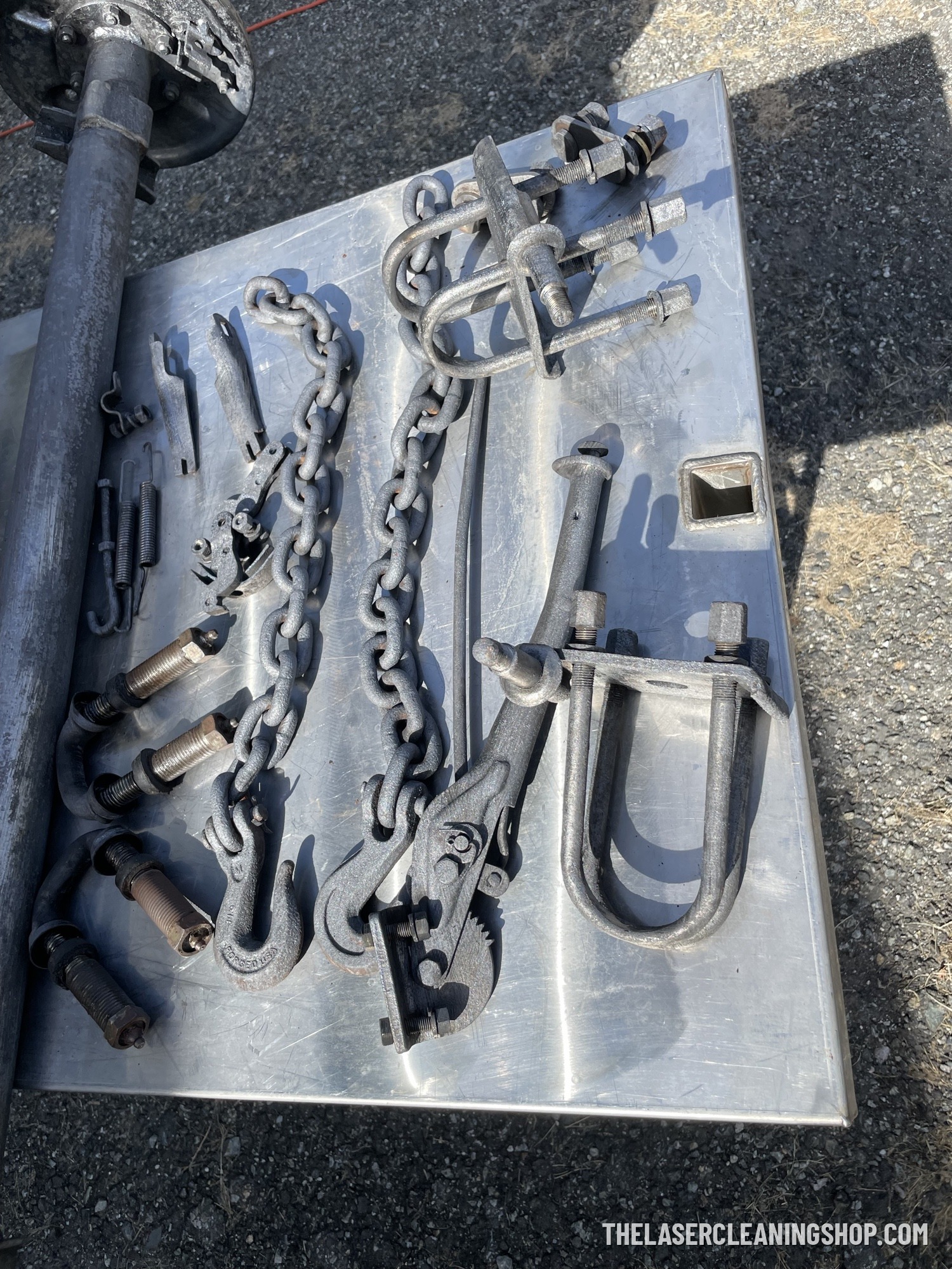 Vintage axle and suspension hardware after laser cleaning