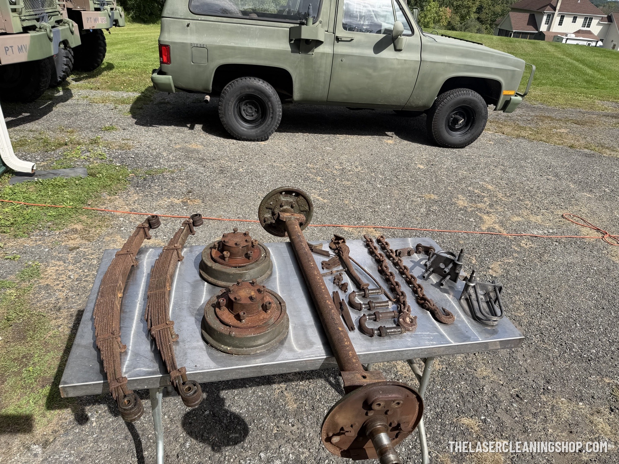 Vintage axle and suspension hardware before laser cleaning — heavy rust