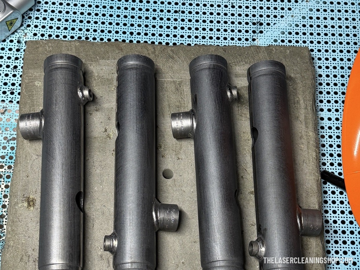 Industrial steel fire-safety manifolds after laser cleaning — bare steel