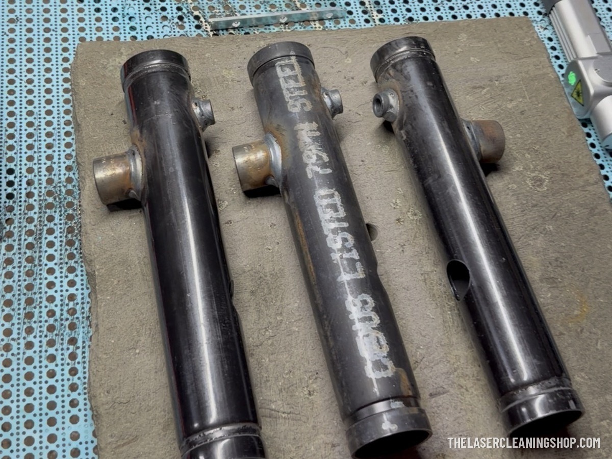 Industrial steel fire-safety manifolds before laser cleaning — mill scale, rust, and markings