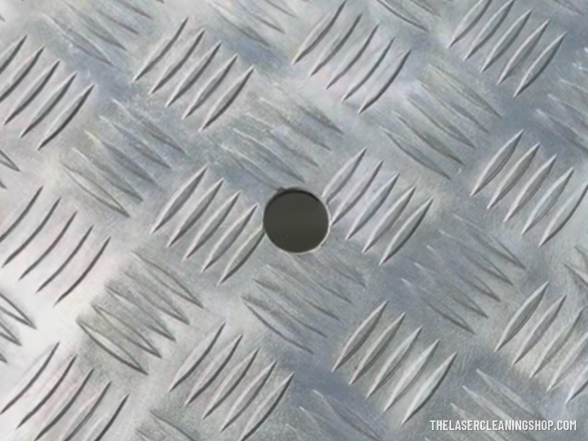 Yacht engine room aluminum diamond-plate floor panel after laser cleaning — bright bare aluminum