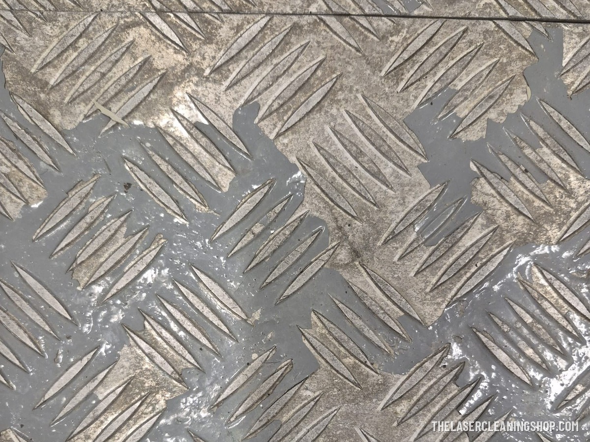 Yacht engine room aluminum diamond-plate floor panel before laser cleaning — worn grey coating and grime