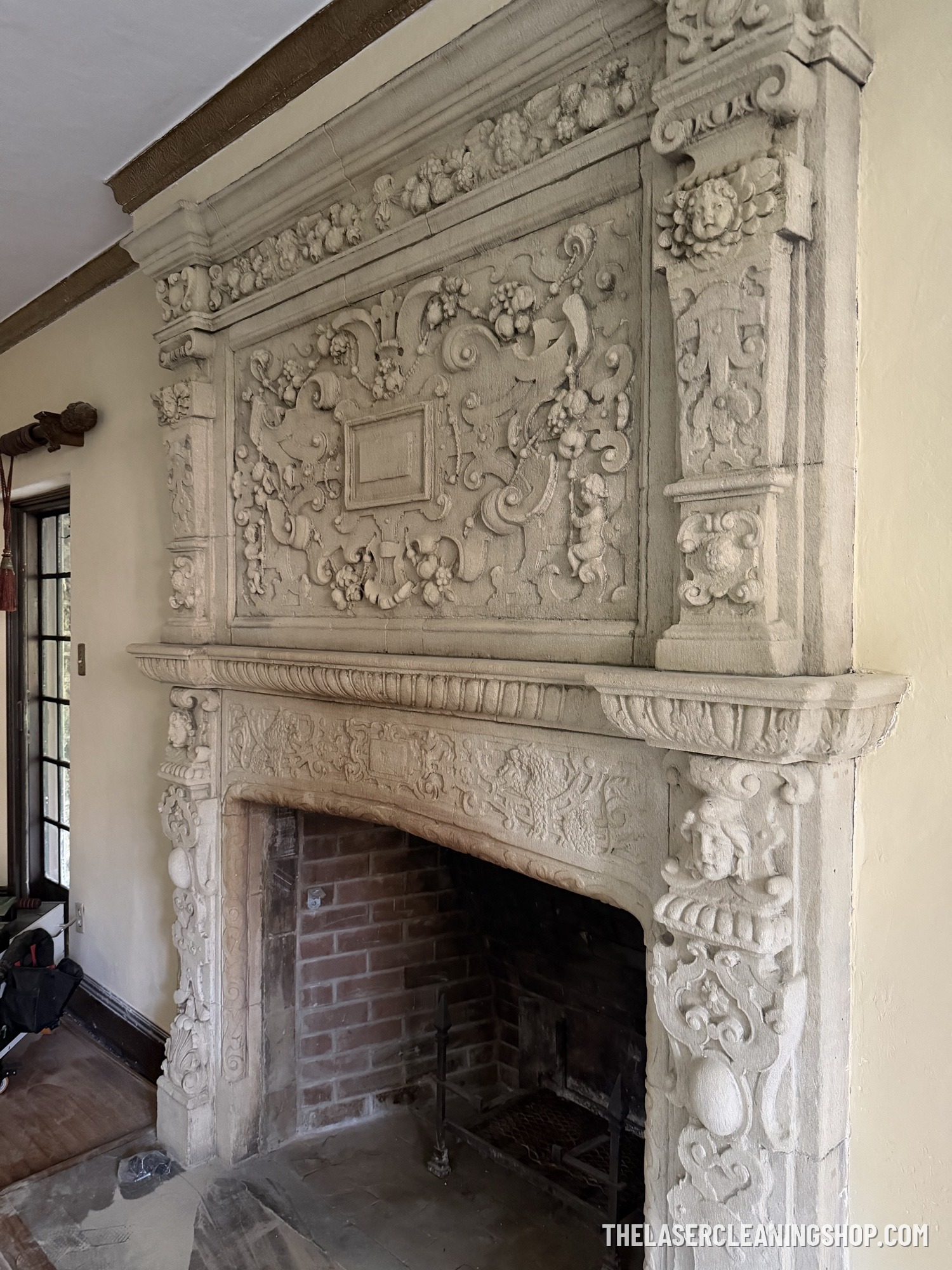 Ornate carved stone fireplace mantel restoration — historic masonry laser cleaning